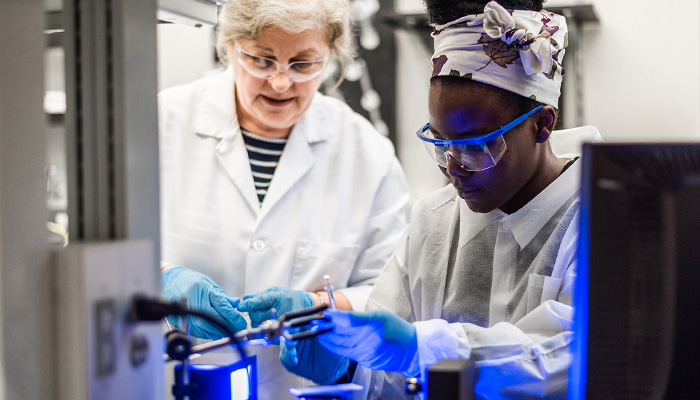 chemist in lab with student